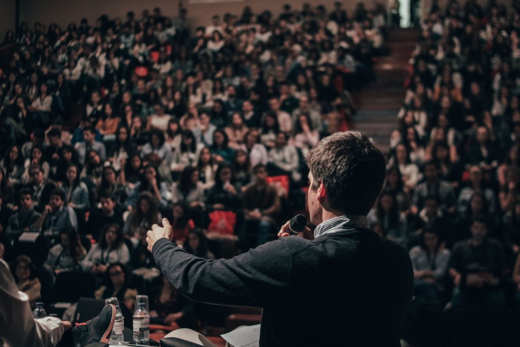 Image of man speaking to a large crowd